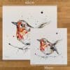 Two prints of Peekaboo, a robin print by Kathryn Callaghan, to show the size difference between the 45cm print and the 30cm print.