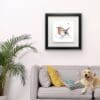 Peekaboo robin print shown in deluxe black frame in situ