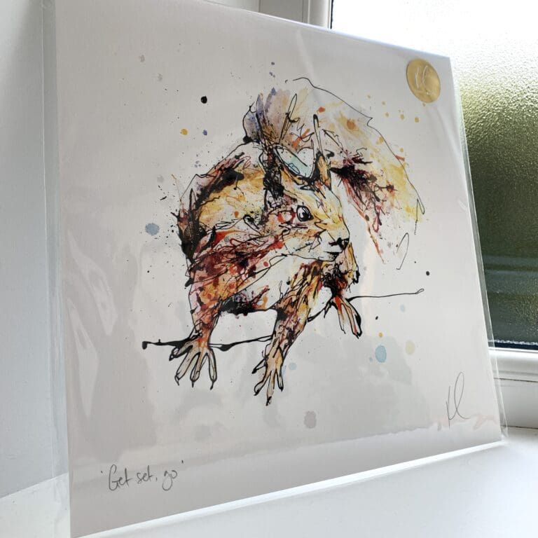 A print of Get Set, Go! by Kathryn Callaghan, which features an energetic red squirrel. The 30cm print is presented flat in a clear cello bag with a golden KC sticker in the top right.