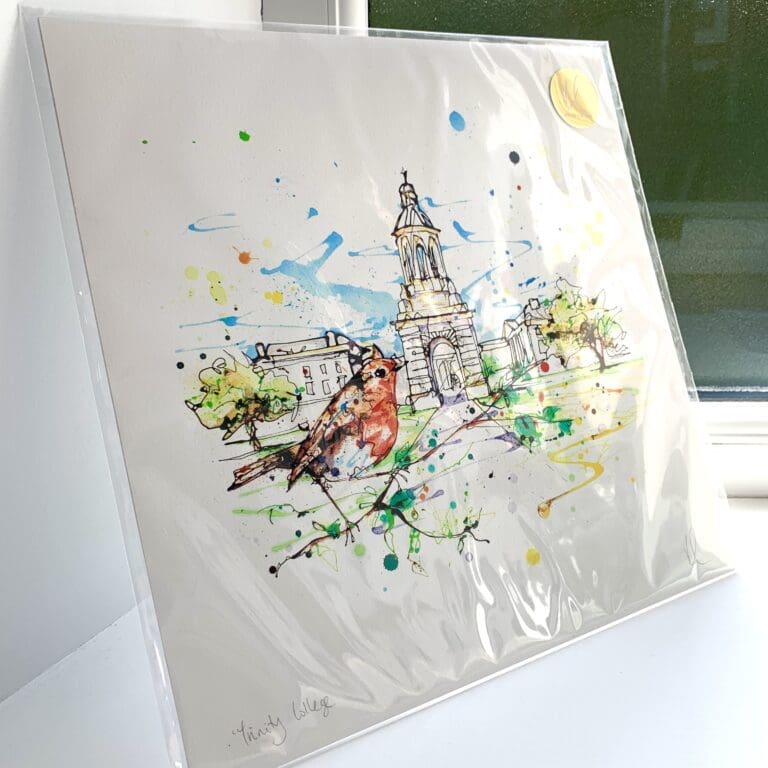 A print of Trinity College by Kathryn Callaghan, which features the historic Dublin university with a perched robin in the foreground. The 30cm print is presented flat in a clear cello bag with a golden KC sticker in the top right.