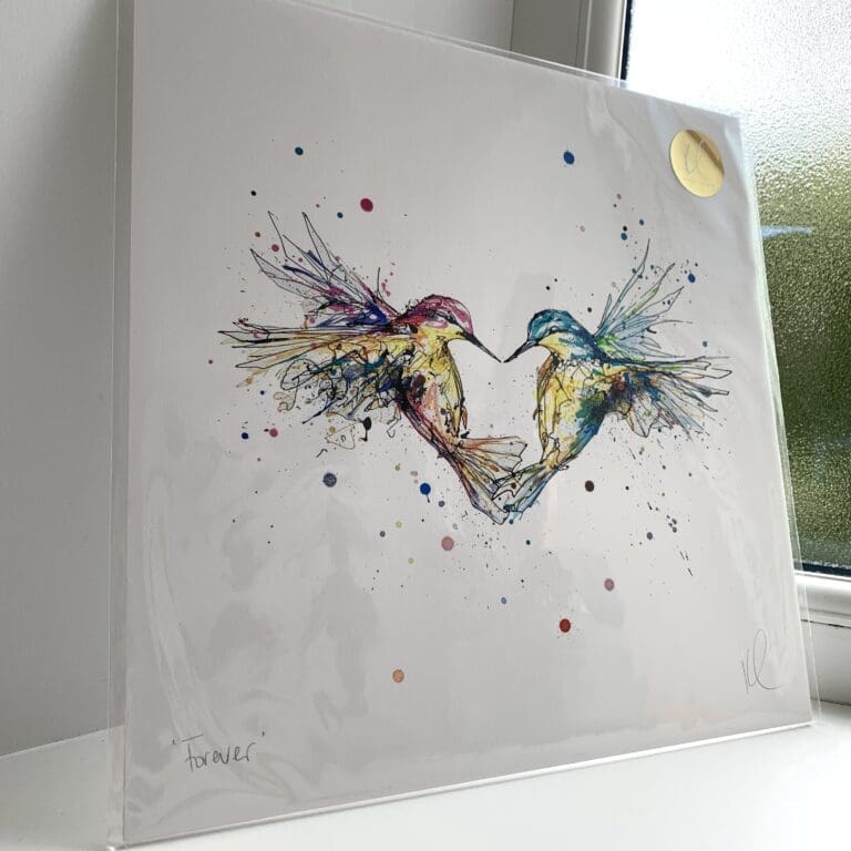 A print of Forever by Kathryn Callaghan, which features two hummingbirds flying in a heart shape. The 30cm print is presented flat in a clear cello bag with a golden KC sticker in the top right.