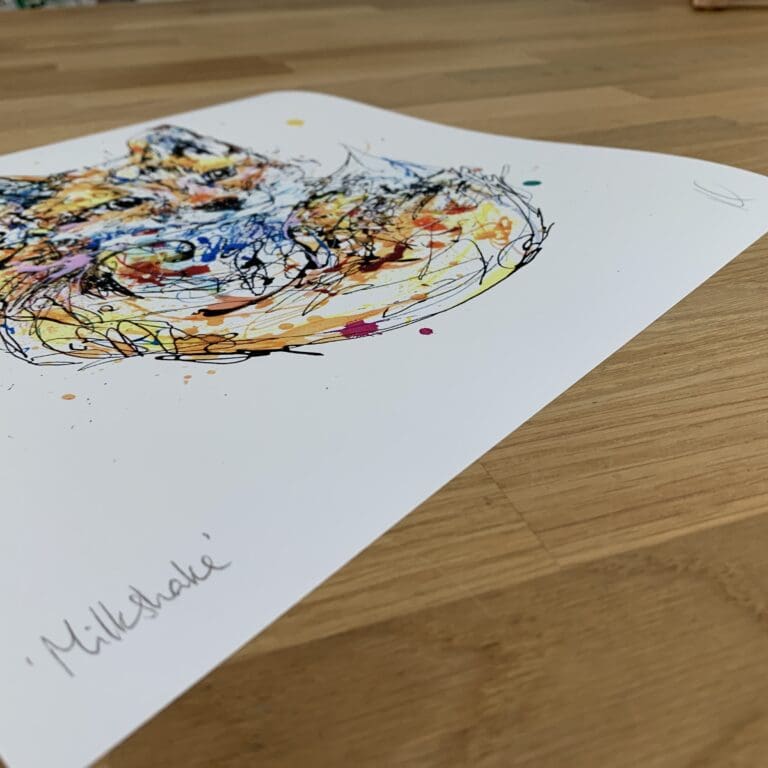 Photograph of Milkshake, a print of a fox cub curled up and looking at the viewer by Kathryn Callaghan, which shows the print's title handwritten in the bottom left corner and the artist's signature in the bottom right, with space between to add a custom personalisation.