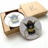 A set of coasters featuring a bee print by Kathryn Callaghan named Buzz