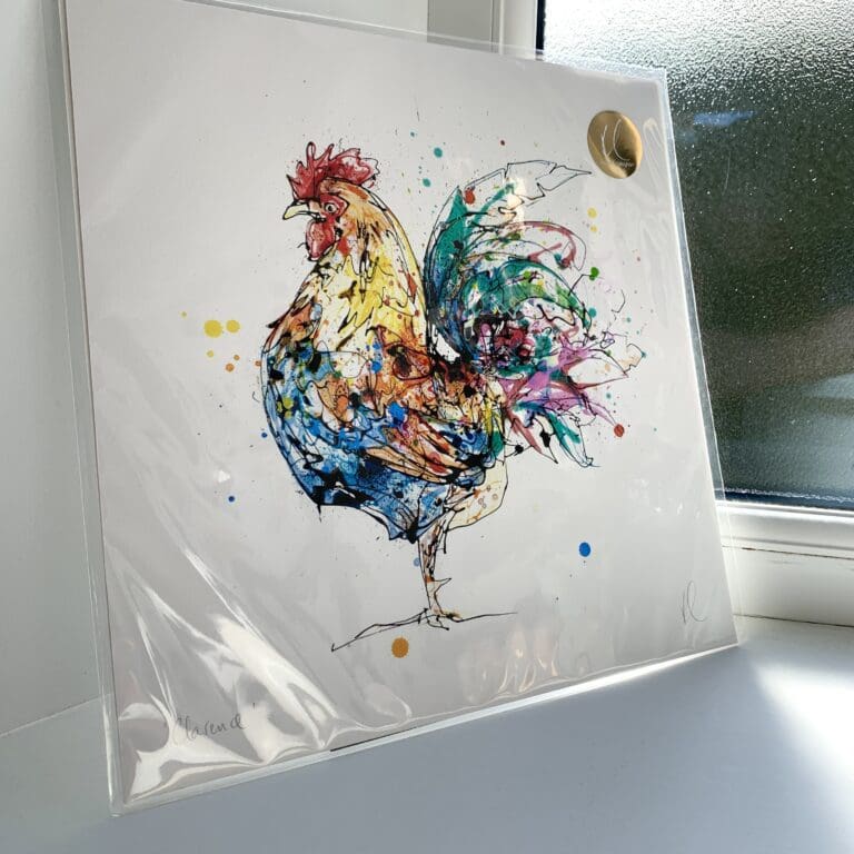 A print of Clarence by Kathryn Callaghan, which features a colourful cockerel. The 30cm print is presented flat in a clear cello bag with a golden KC sticker in the top right.