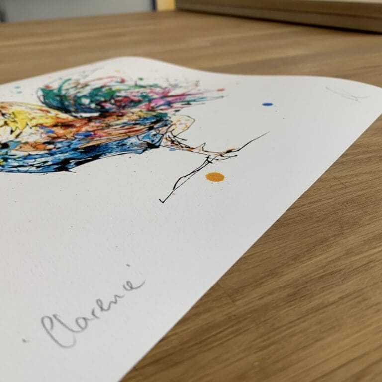 Photograph of Clarence, a print of a colourful cockerel by Kathryn Callaghan, which shows the print's title handwritten in the bottom left corner and the artist's signature in the bottom right, with space between to add a custom personalisation.