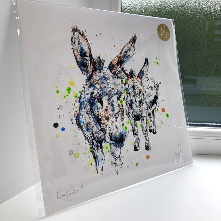 A print of Companions by Kathryn Callaghan, which features a cheerful hare's face. The 30cm print is presented flat in a clear cello bag with a golden KC sticker in the top right.