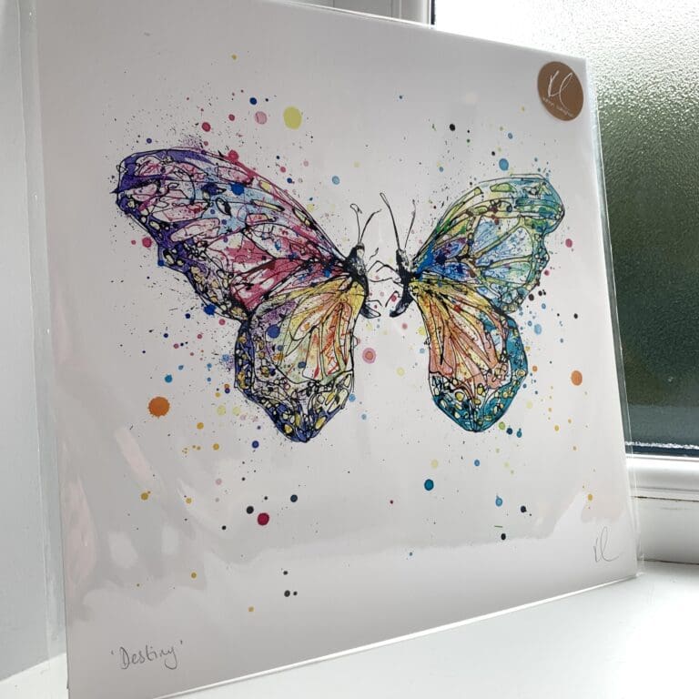 A print of Destiny by Kathryn Callaghan, which features a pair of colourful butterflies coming together. The 30cm print is presented flat in a clear cello bag with a golden KC sticker in the top right.