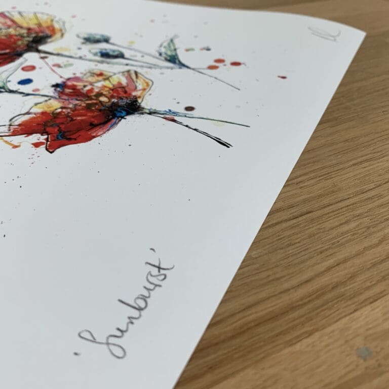 Photograph of Sunburst, a print of two poppies by Kathryn Callaghan, which shows the print's title handwritten in the bottom left corner and the artist's signature in the bottom right, with space between to add a custom personalisation.