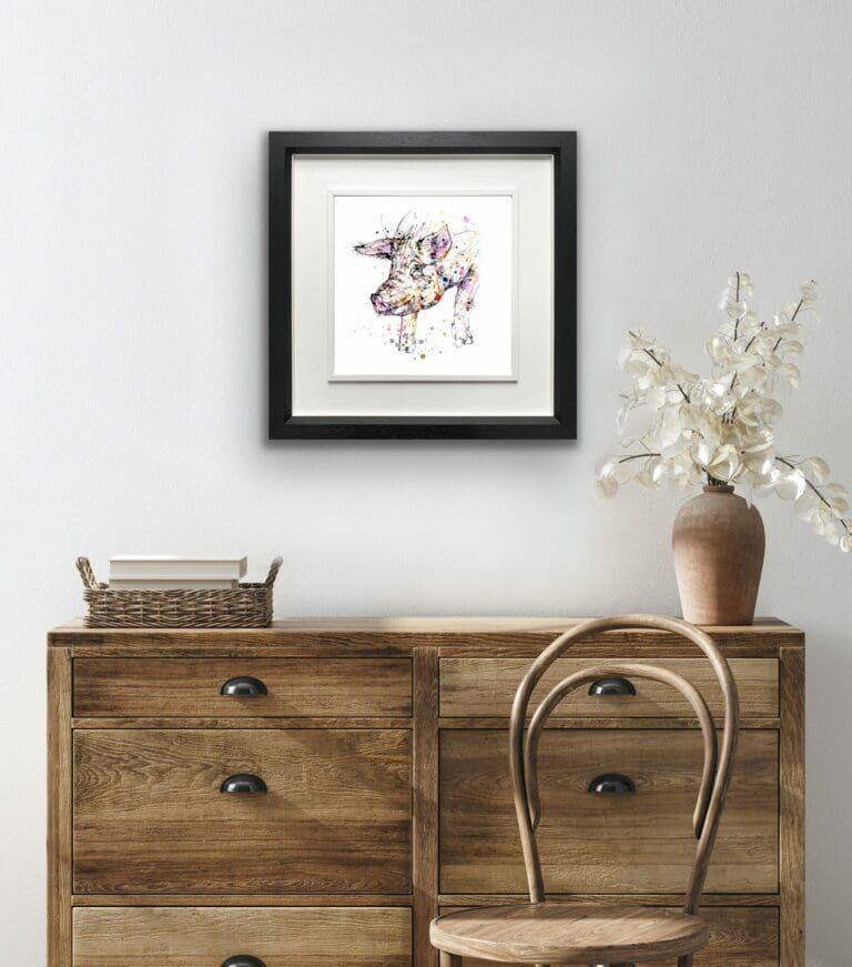 Truffles Pig Print shown in Deluxe Black Frame in Situ above desk