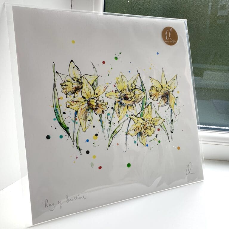 A print of Ray of Sunshine by Kathryn Callaghan, which features the a spray of five yellow daffodils. The 30cm print is presented flat in a clear cello bag with a golden KC sticker in the top right.