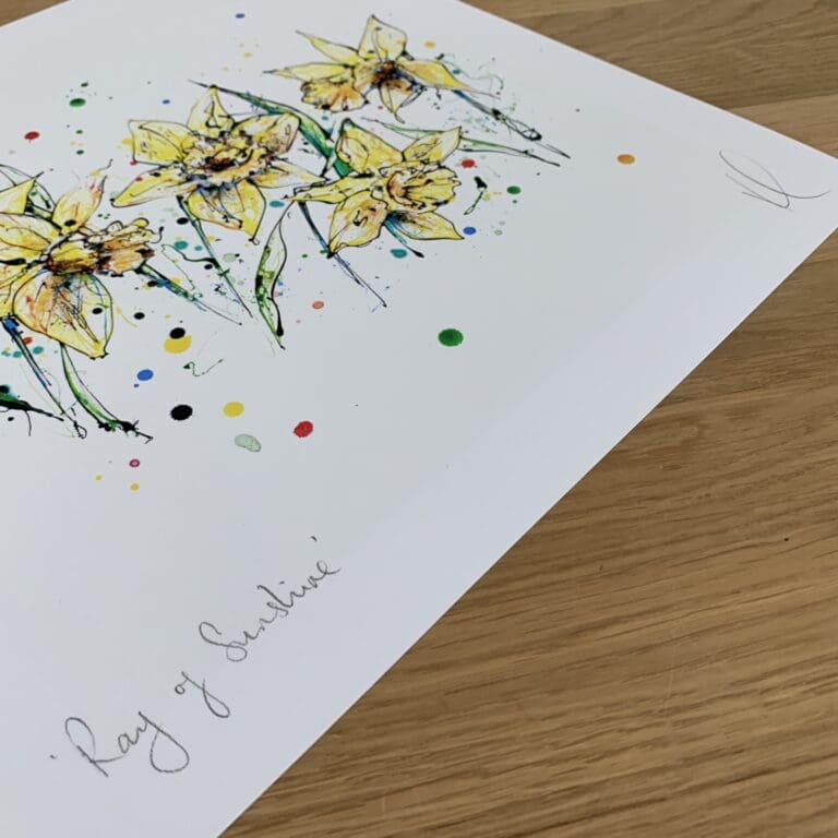 Photograph of Ray of Sunshine, a print of five yellow daffodils by Kathryn Callaghan, which shows the print's title handwritten in the bottom left corner and the artist's signature in the bottom right, with space between to add a custom personalisation.