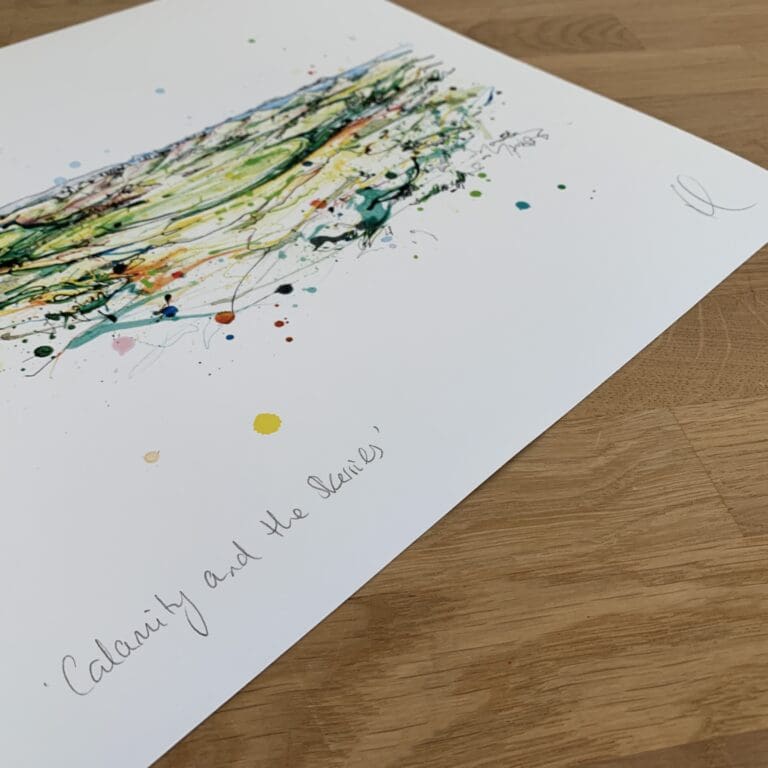 Photograph of Calamity Corner and the Skerries by Kathryn Callaghan, which shows the print's title handwritten in the bottom left corner and the artist's signature in the bottom right, with space between to add a custom personalisation.