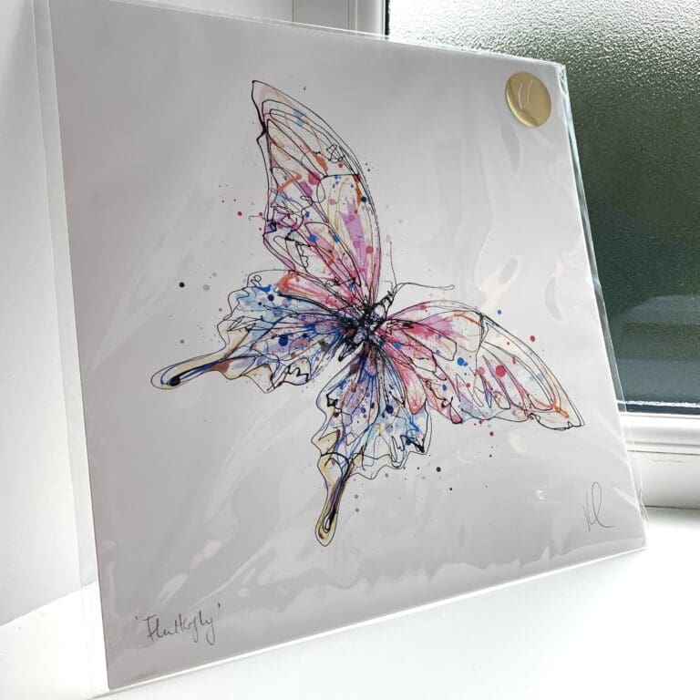 A print of Flutterfly by Kathryn Callaghan, which features a pink and blue butterfly. The 30cm print is presented flat in a clear cello bag with a golden KC sticker in the top right.