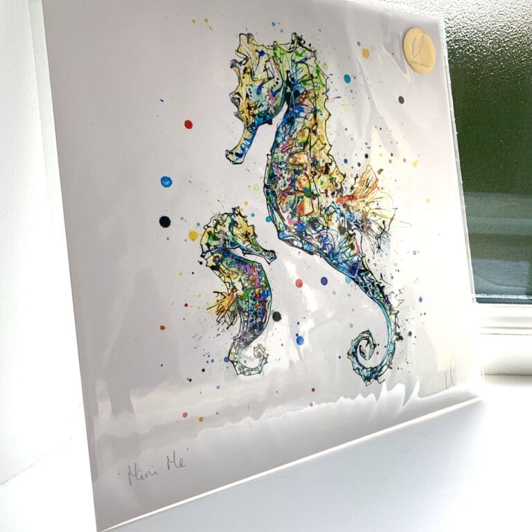 A print of Mini Me by Kathryn Callaghan, which features an adult and baby seahorse in tones of blue, green and yellow. The 30cm print is presented flat in a clear cello bag with a golden KC sticker in the top right.