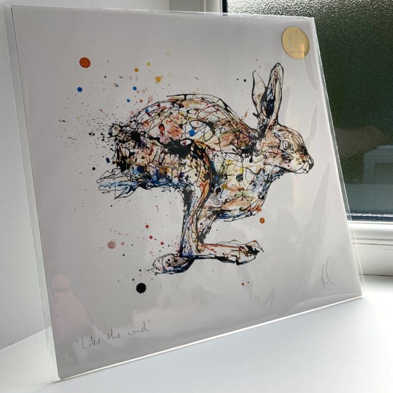 A print of Like the Wind by Kathryn Callaghan, which features a hare running from left to right. The 30cm print is presented flat in a clear cello bag with a golden KC sticker in the top right.