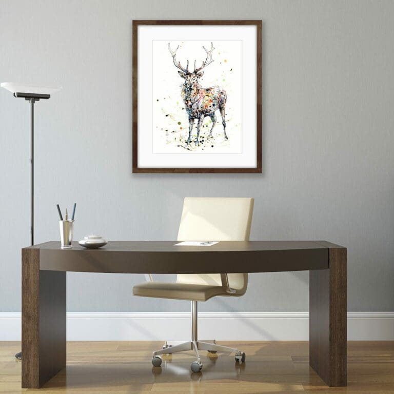 Empowered stag limited edition print displayed in dark wood frame behind an office desk