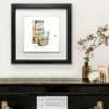 A Wee Night Cap Whiskey Print displayed in Deluxe Black Frame in Situ