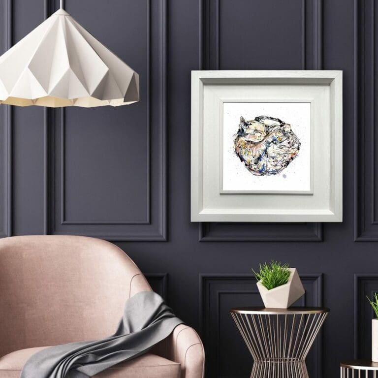 Catnap Cat Print shown in Deluxe White Frame in situ in grey room with pink armchair