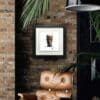 The Black Stuff Guinness Print displayed in Deluxe Black Frame in Situ on a brick wall