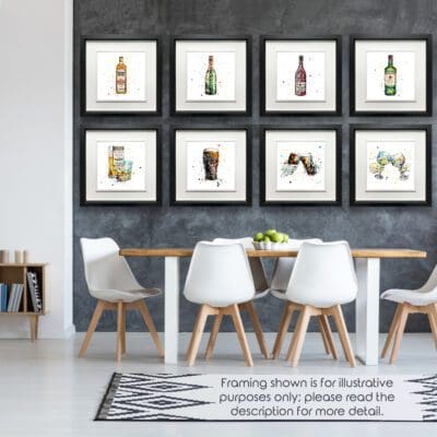 Eight prints are shown in Deluxe Black Frames in a well lit grey and white dining room. The prints are Bushmills Irish Whiskey, Belle Époque, Red, Jameson Irish Whiskey, A Wee Night Cap, The Black Stuff, Cheers, and Good Times, all by Kathryn Callaghan.