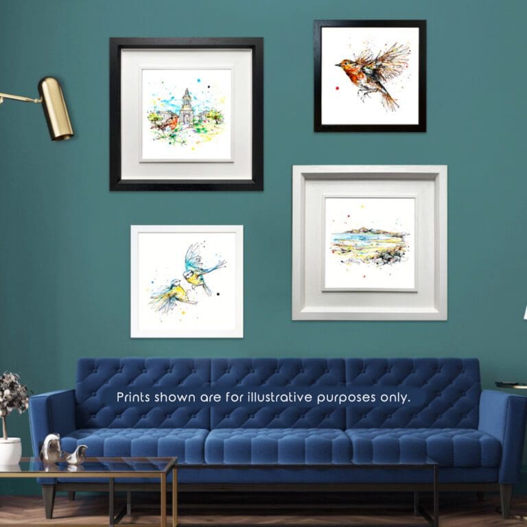 Two landscape prints hung in deluxe frames and two bird prints hung in standard frames shown in situ on a teal wall with a dark blue sofa.