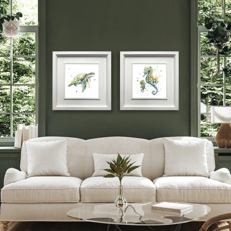 Mini Me and Tranquil prints shown in Deluxe White Frames in Situ on a dark green wall above a cream sofa