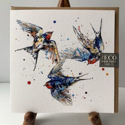 Greetings card featuring a poured painting of three swallows by Kathryn Callaghan. A sticker on the card reads "The Eco Friendly Card Company".