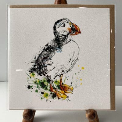 Greetings card featuring a poured painting of an Atlantic Puffin by Kathryn Callaghan. A sticker on the card reads "The Eco Friendly Card Company".