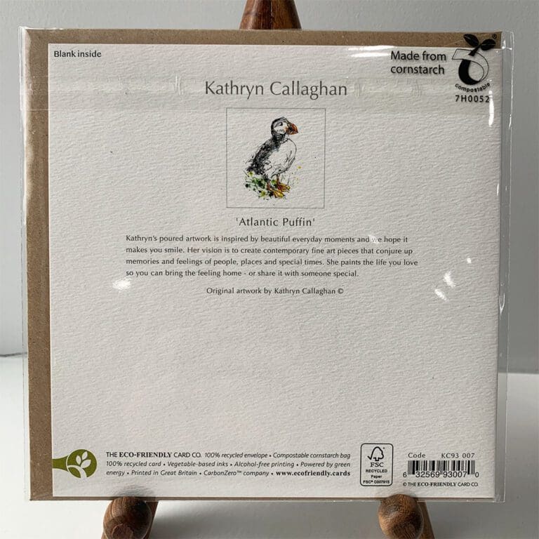 Reverse of a recycled paper card featuring Atlantic Puffin by Kathryn Callaghan. The reverse has text reading "Kathryn's poured artwork is inspired by beautiful everyday moments and we hope it makes you smile. Her vision is to create contemporary fine art pieces that conjure up memories and feelings of people, places and special times. She paints the life you love so you can bring the feeling home - or share it with someone special."