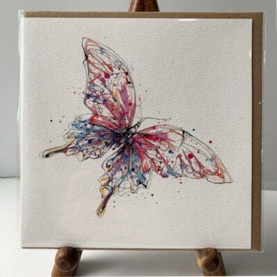 Greetings card featuring a poured painting of a pink butterfly by Kathryn Callaghan. A sticker on the card reads "The Eco Friendly Card Company".