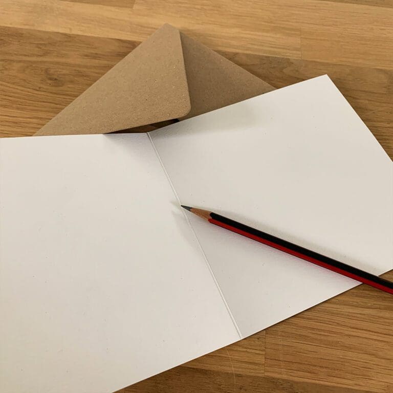 Blank inner of an eco friendly paper card by Kathryn Callaghan, with a recycled brown envelope and red and black pencil.