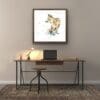 Treasure Hunt, a print of a fox by Kathryn Callaghan, is shown framed in situ above a simple office desk.