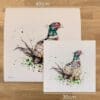 Two prints of Attention, a pheasant print by Kathryn Callaghan, to show the size difference between the 45cm print and the 30cm print.