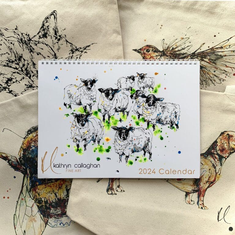 The Kathryn Callaghan 2024 Calendar, featuring a cover image of a painted flock of sheep named Baa, shown laid atop the four available canvas bucket bag designs. The designs available are robin in flight named Airborne, a dachshund named Hopeful, a bee named Buzz, and a sleeping black and white cat named Dreamer.