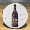A coaster featuring the red wine print "Red" by Kathryn Callaghan