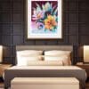 As Night Falls, a mauve floral print by Kathryn Callaghan, shown in a gold frame in situ in a cosy dark bedroom with wood panelling.