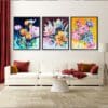 Three floral prints by Kathryn Callaghan shown in situ in a cream and red living room. Left to right the prints are Midnight Dreams, which features tulips on a dark blue background, As Night Falls, which features tulips on a mauve background, and First Light, which features tulips on an ochre yellow background.