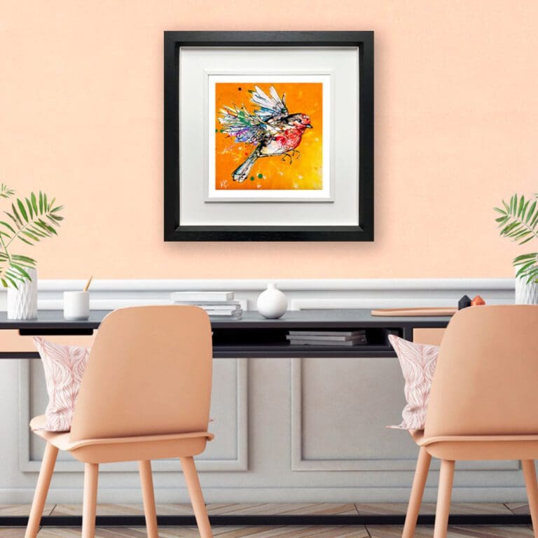 Fly High shown in a Deluxe Black Frame in situ in a clean office with a black desk, white wood panelling, and peach coloured chairs