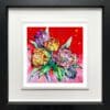 Love, a print of pink, orange, and magenta tulips against a vibrant red background by Kathryn Callaghan, shown in a deluxe black frame.