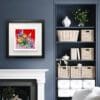 Love shown in a Deluxe Black Frame in a navy room above a white fireplace and beside a built in bookcase