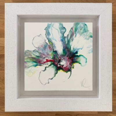 An original abstract painting by Kathryn Callaghan, named Always. The painting features a bloom of pale gree, turquoise, purple, and red blooming from the centre, and is framed in a deep floating white wood frame.