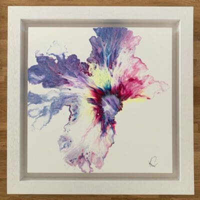 An original abstract painting by Kathryn Callaghan, named Flourish. The painting features a bloom of off-white, blue, deep pink and lilac paint blossoming from the centre, and is framed in a deep floating white wood frame.