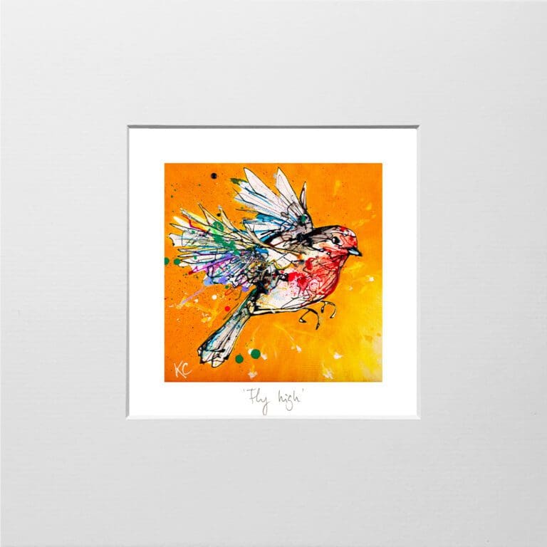 A digital mockup showing how a miniature print of Fly High by Kathryn Callaghan will look presented in a 23cm mount. Fly High features a robin in flight against a bright orange and yellow background, surrounded by a thin border of white where the print's title is printed from a pencil handwritten title.