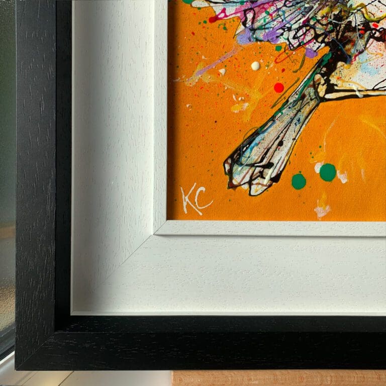 Close up photograph showing the white ink signature and two-part black and white frame used in Fly High, an original painting of a robin by Kathryn Callaghan.