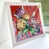 A print of Love by Kathryn Callaghan, which features a posie of flowers against a vivid red background. The 30cm print is presented flat in a clear cello bag with a golden KC sticker in the top right.