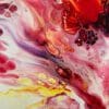 A close up photograph showing the intricate organic detail of reacting red, purple, black and white paints present on Passion, an original abstract painting by Kathryn Callaghan.