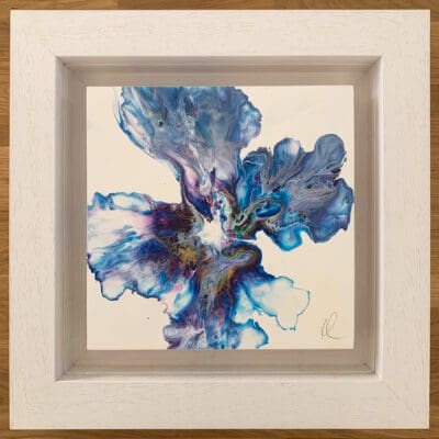 An original abstract painting by Kathryn Callaghan, named Revival. The painting features a bloom of deep blue, vibrant pink, gold, and white blooming from the centre, and is framed in a deep floating white wood frame.