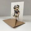 A notecard featuring a print of a terrier named Expectation by Kathryn Callaghan, accompanied by its recycled paper envelope.