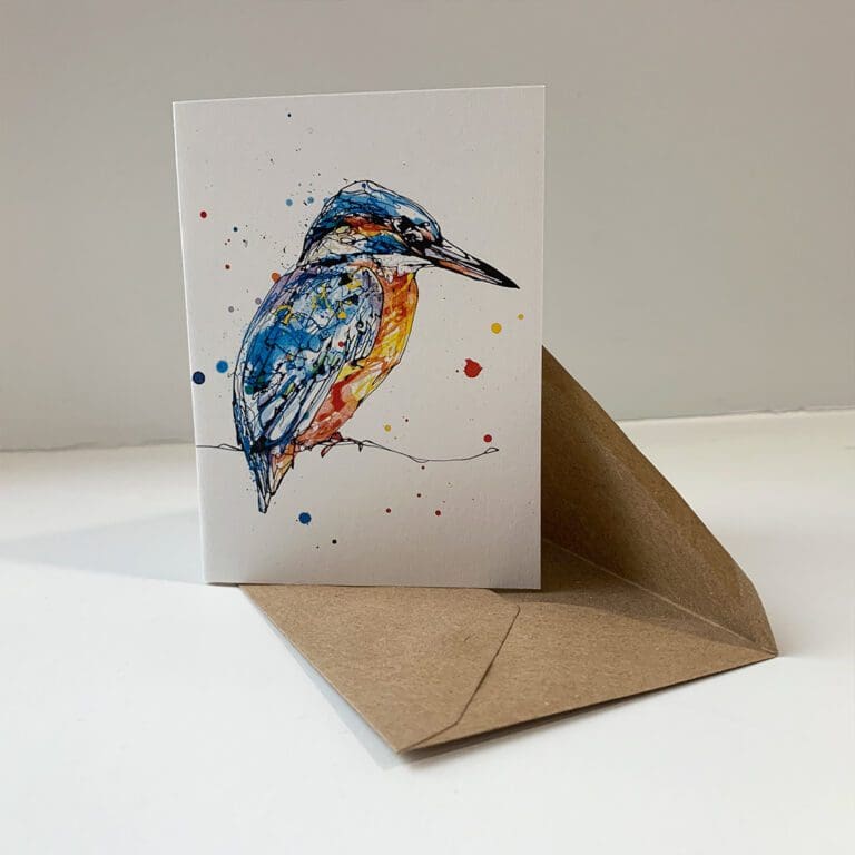 A miniature notecard featuring a print of a kingfisher by Kathryn Callaghan, entitled Gaze. The card sits open on a brown envelope.