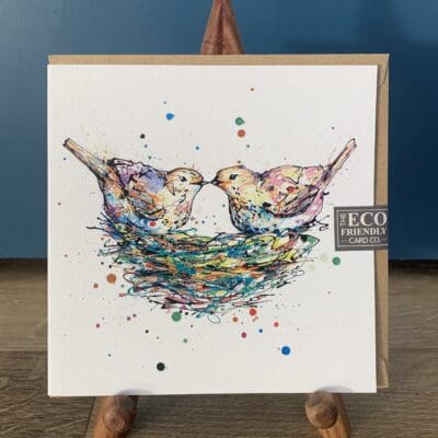 Greetings Card featuring a poured painting of two pastel pink and yellow doves sitting on a colourful nest. The print is named Our Nest and is by Kathryn Callaghan.